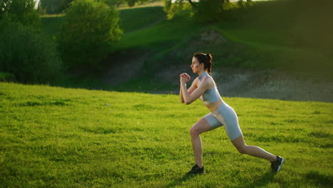 A-woman-in-the-park-performs-lunges-on-each-leg-in-the-morning.-Morning-training.